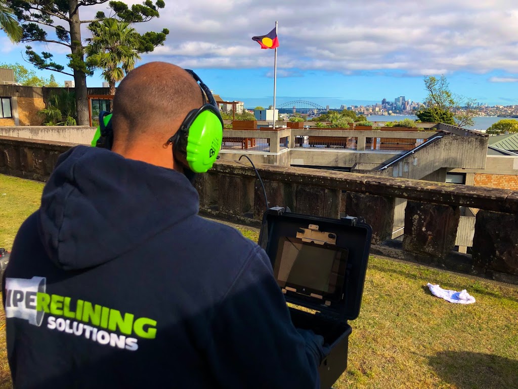 Pipe Relining Solutions wearing a headphone while inspecting camera footage